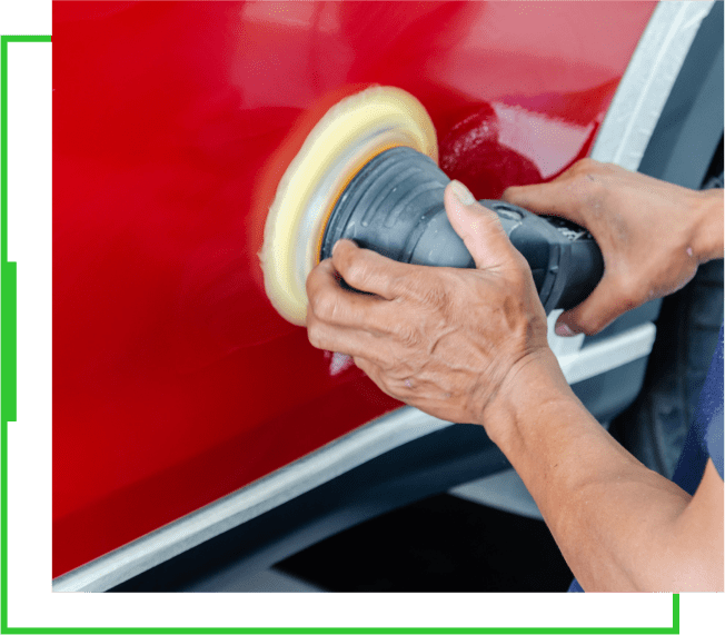 A person is using a polisher to clean the paint on a car.